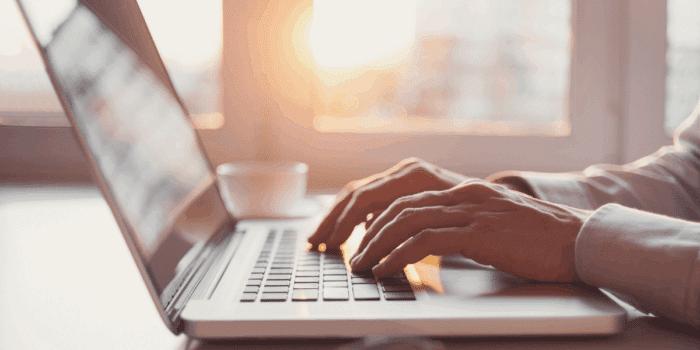 person typing on laptop