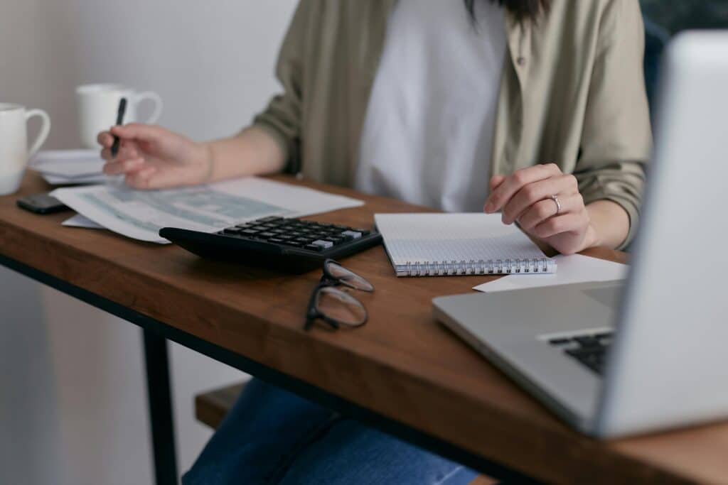 person reviewing paperwork at desk